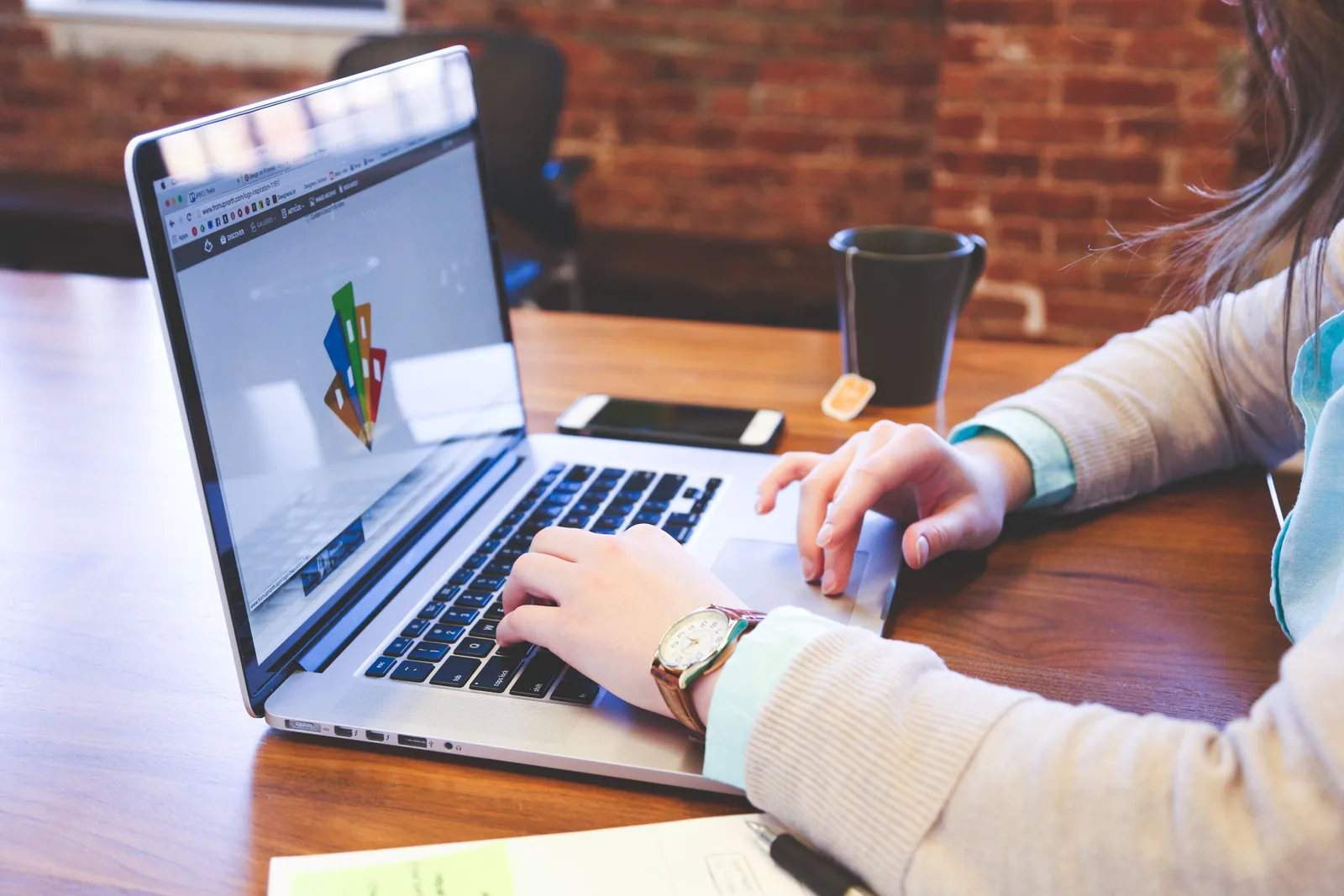 Designer working on a brand layout on a laptop