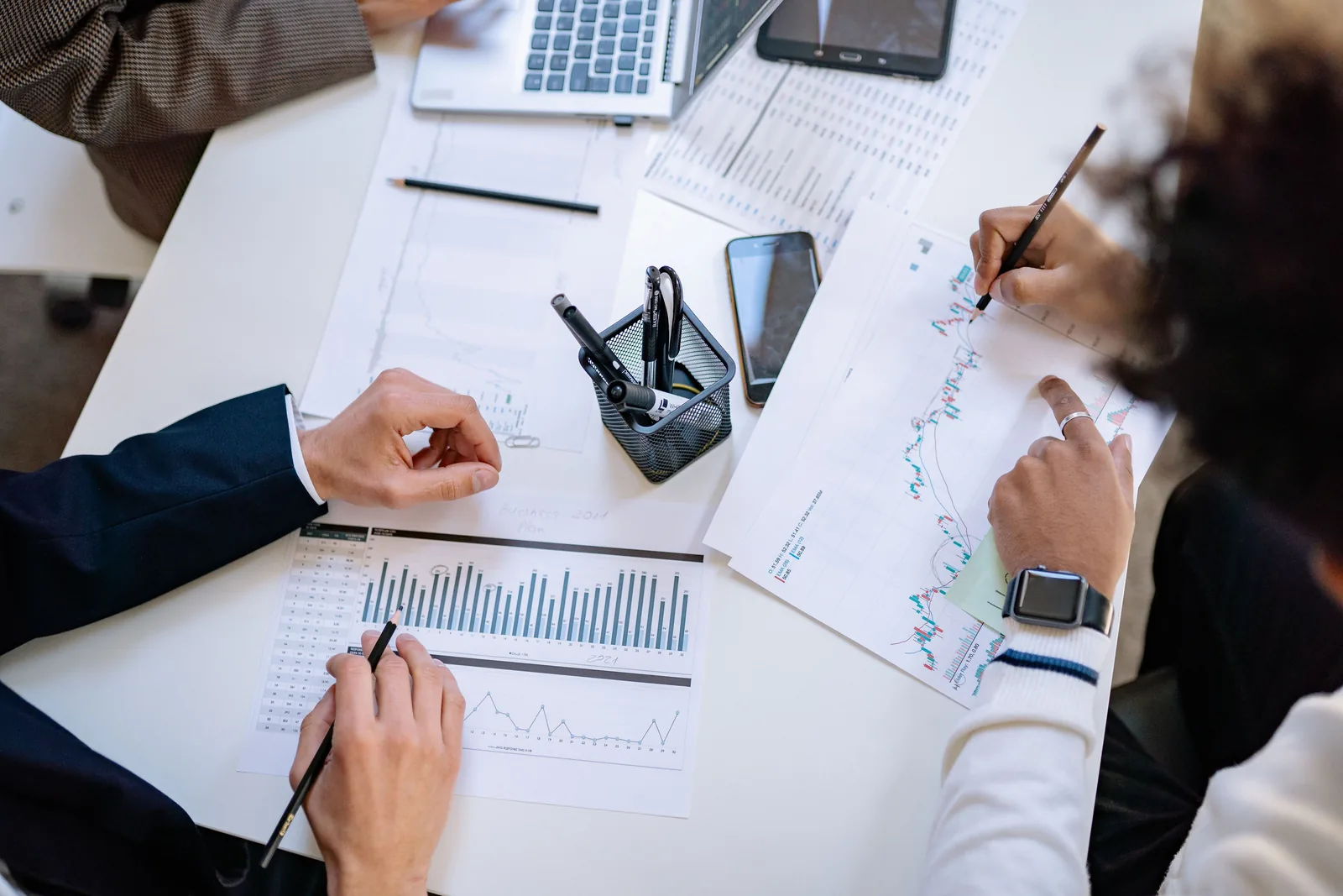Monthly numbers and charts reviewed across a desk